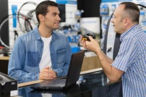 Man returning the defective product to the salesman.