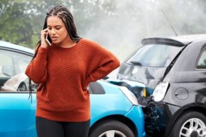 Female driver calling police to report accident.