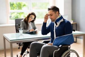 Man on wheelchair filing for disability claims.