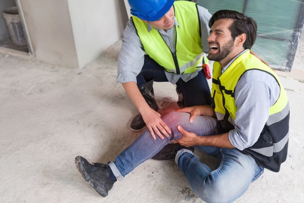 Construction worker suffering knee injuries at work.
