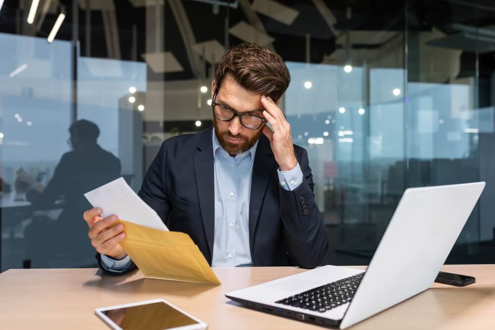 Businessman reading demand letter.